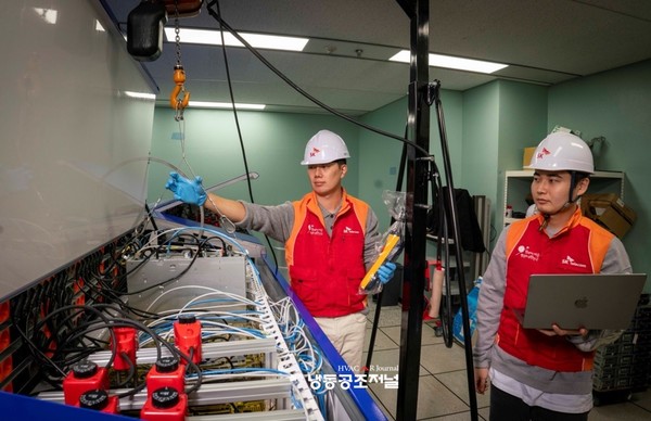 SKT 직원들이 인천 사옥에 설치된 액침냉각 테스트 장비를 점검하고 있다